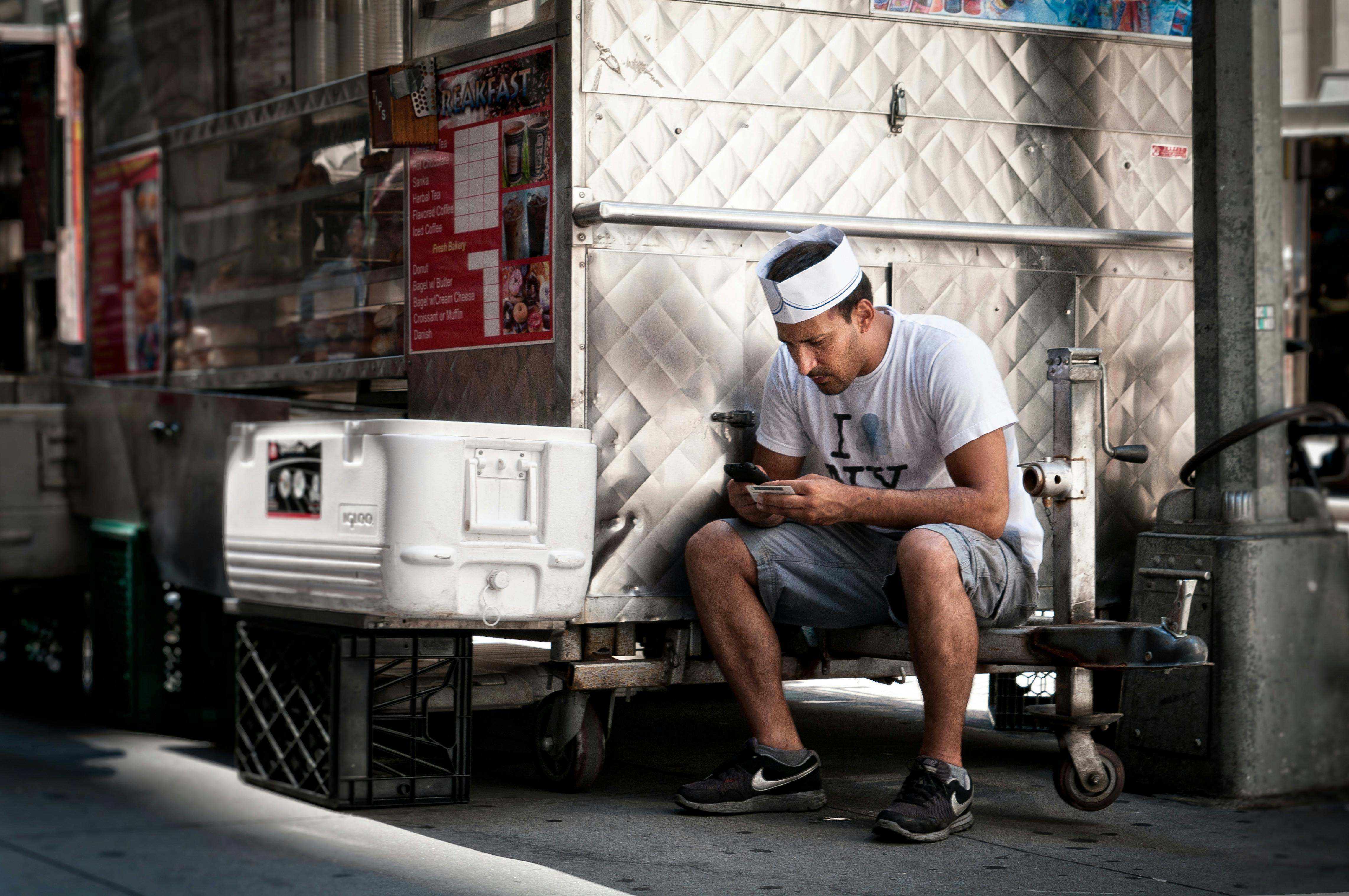 Man Sitting While Using Smartphone \u00b7 Free Stock Photo