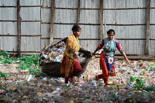 Women Pulling a Bag of Recycled Trash 