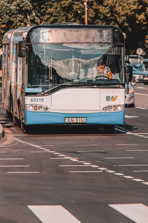Free A city bus in Riga, Latvia, travels along a street featuring a pedestrian crosswalk. Stock Photo