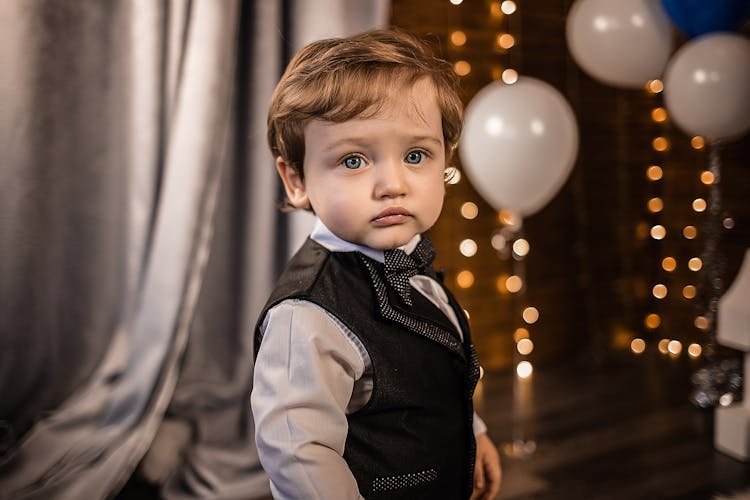 Cute Little Boy In Suit In Restaurant