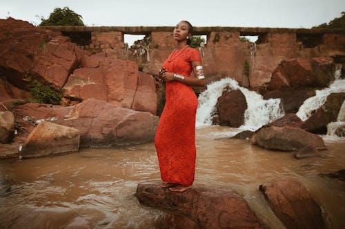 Woman in Red Dress Against Creek