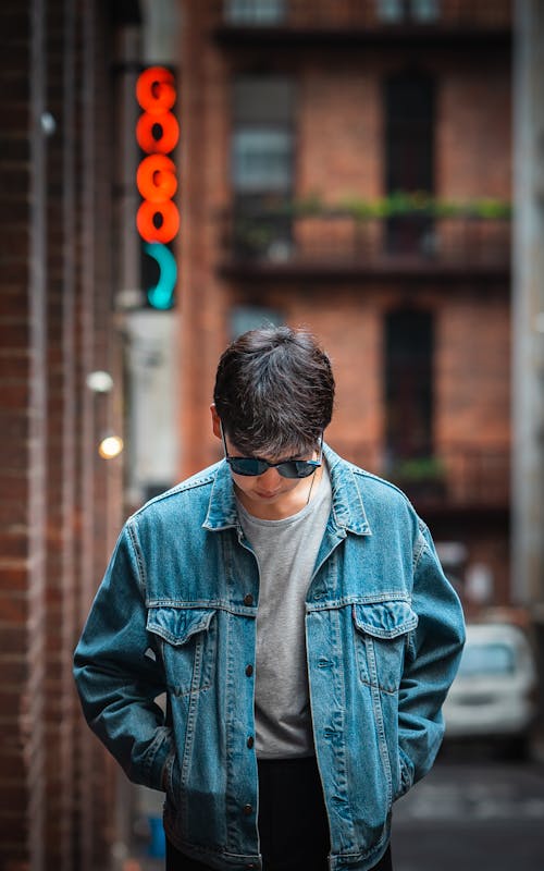 A Man in Blue Denim Jacket Wearing Sunglasses