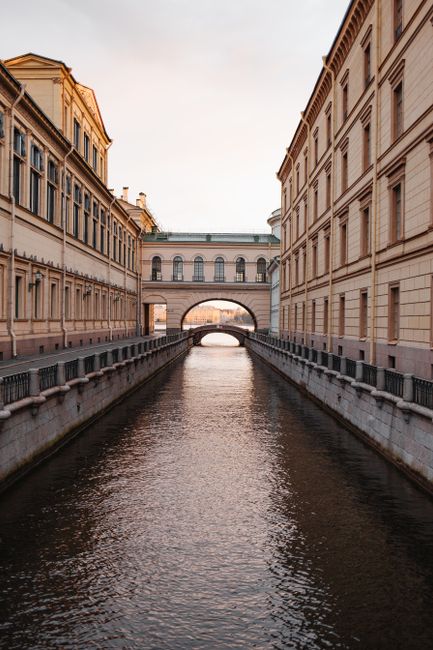 Scenic view of a historic canal flanked by classic buildings in Saint Petersburg, Russia.
