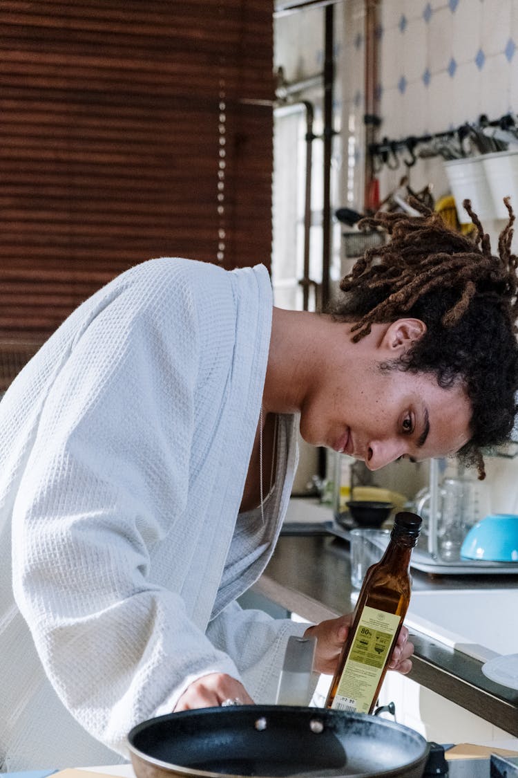 Man In White Robe Cooking In The Kitchen