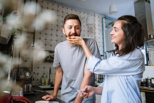 Cheerful couple sharing a morning meal in a cozy kitchen, enjoying each other's company.