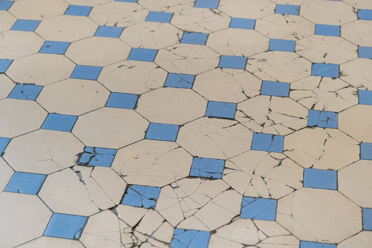 Damaged White And Blue Tiled Floor