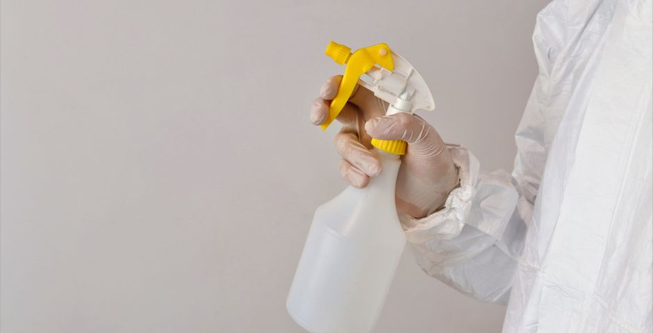 A gloved hand with a spray applicator — how a product is applied changes the exposure entirely