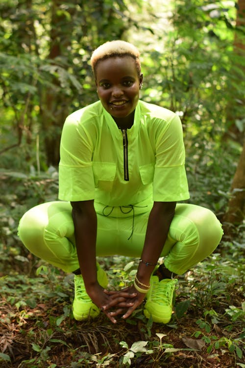 A Woman in Yellow Green Clothes Sitting in the Forest