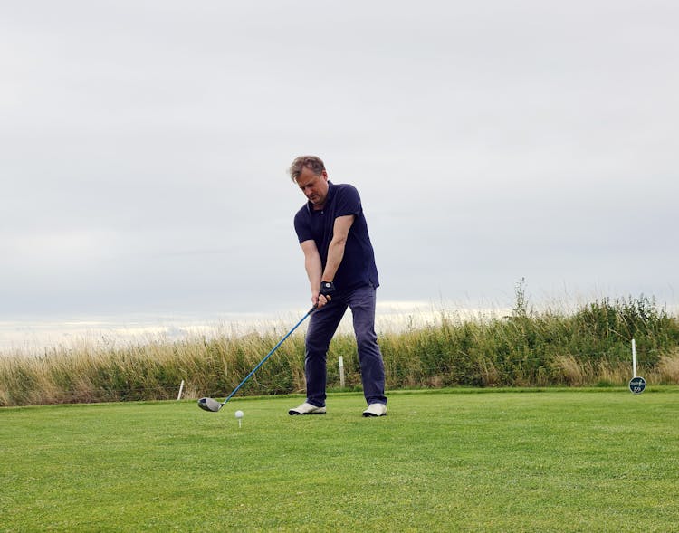 Man In Black Polo Shirt Playing Golf