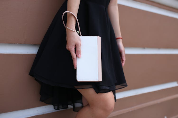 Woman In Black Dress Holding White And Pink Wallet