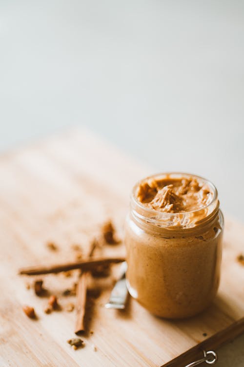 Jar with Peanut Butter on Table