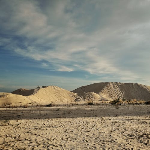 Hills of Sand Under Blue Sky