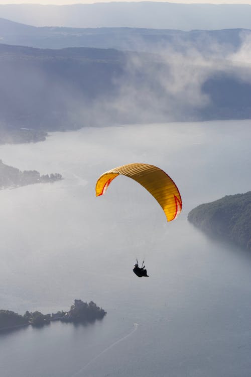 Paraglider flying over calm sea