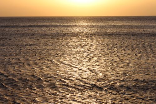 Free Spectacular seascape with rippling sea with horizon against yellow sundown sky in nature in tropical country in evening time outside Stock Photo