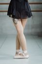 Crop faceless ballerina standing in fifth position in studio