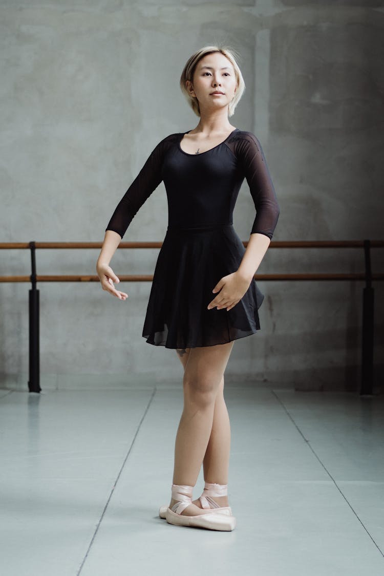 Ethnic Ballerina Standing In Fifth Position In Studio