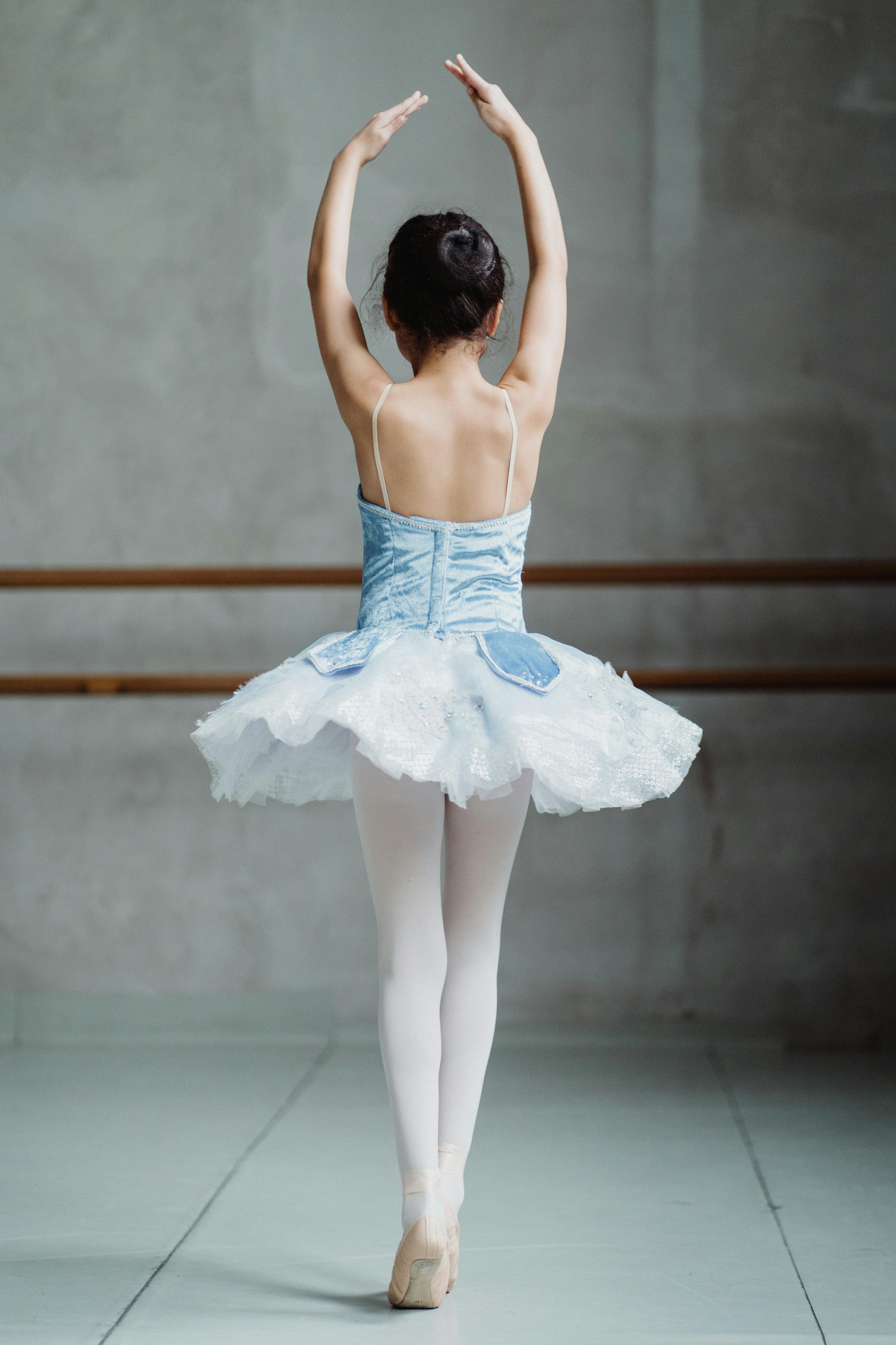 ballet dancer on tiptoes with hands up