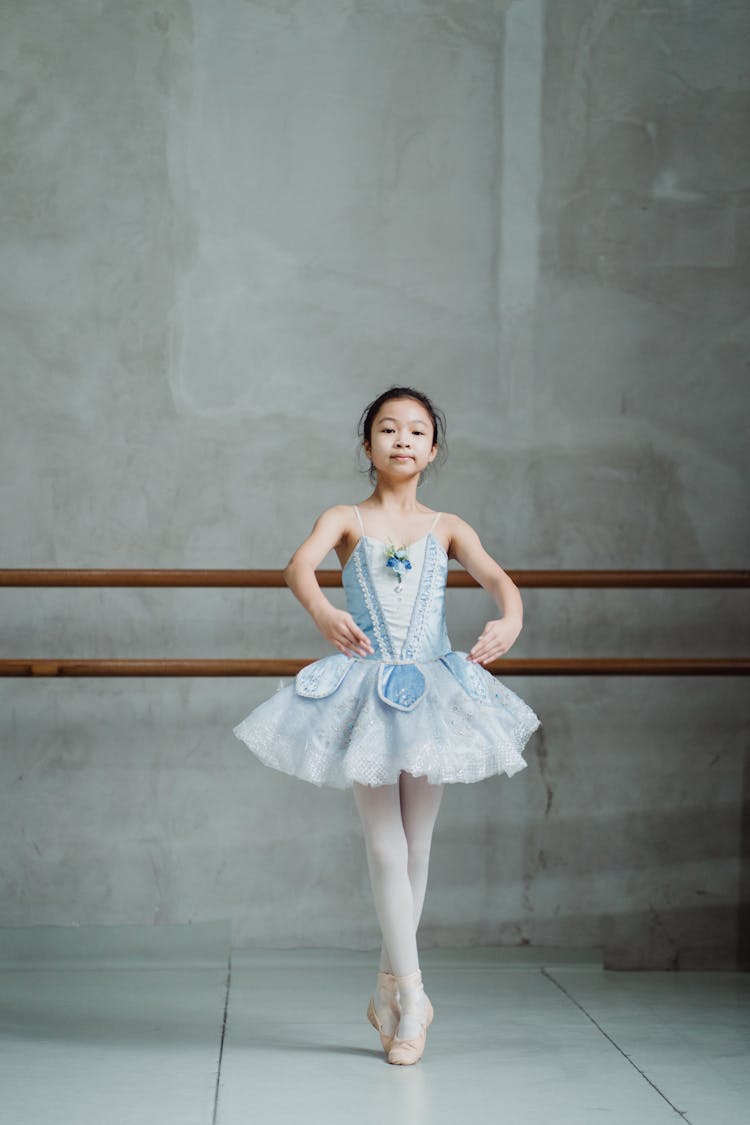 Ethnic Ballerina Dancing In Pointe Shoes In Dance Hall