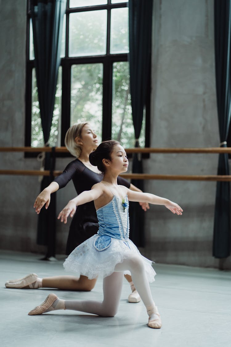 Little Ethnic Ballerina Practicing Ballet With Coach