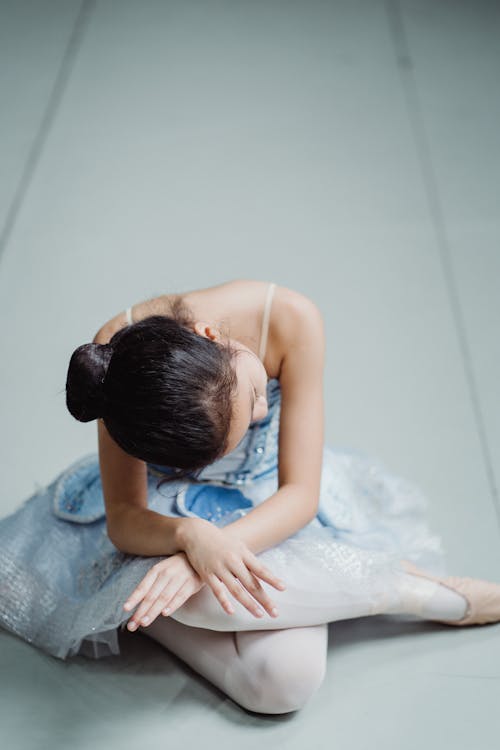 Free Girl in tutu on floor with crossed legs and arms Stock Photo
