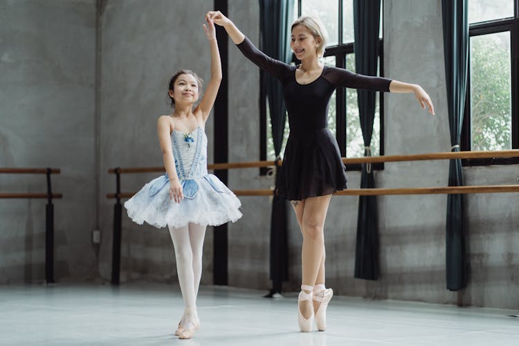 Asian Girl Practicing Ballet With Teacher