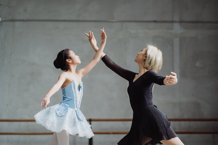 Asian Ballet Teacher Dancing With Student