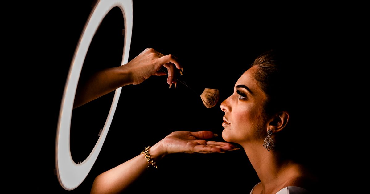 A large ring light illuminating a subject at close range, showing the even, shadow-free light output typical of ring lights.