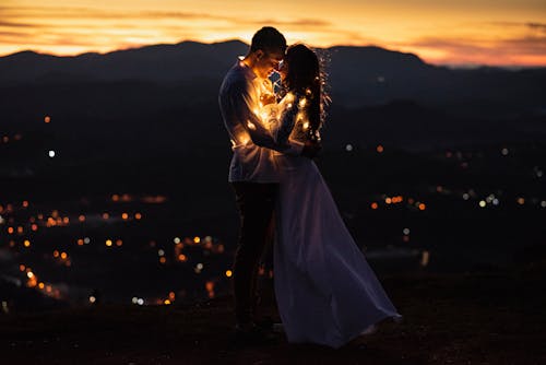 Man and Woman Kissing During Sunset