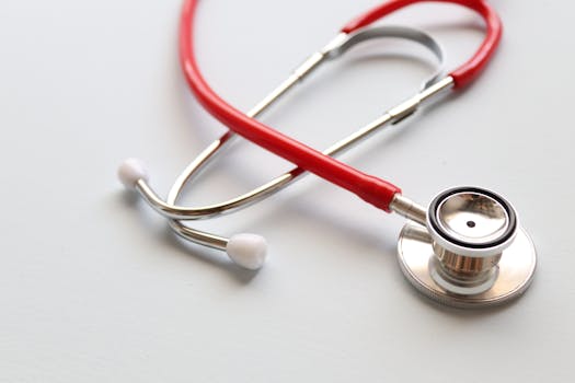 Close-up of a red stethoscope symbolizing medical care and healthcare diagnostics.
