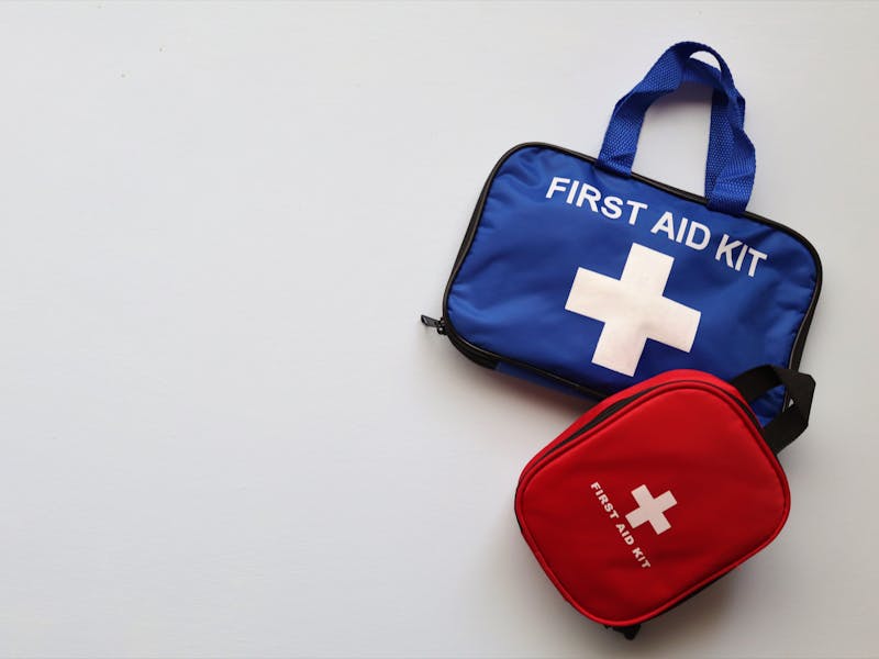 Comprehensive home emergency kit organized with water, food, first aid, and communication supplies