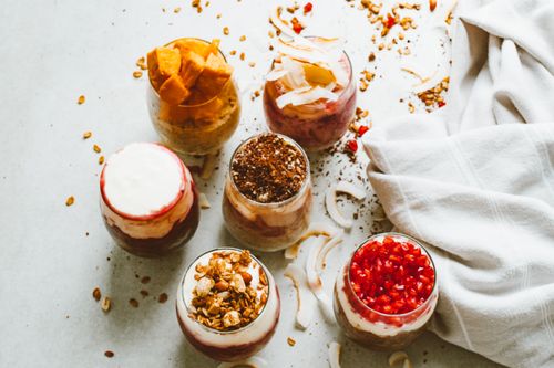 Free Top-down view of assortment of delicious yogurt parfaits topped with fresh fruits and granola. Stock Photo