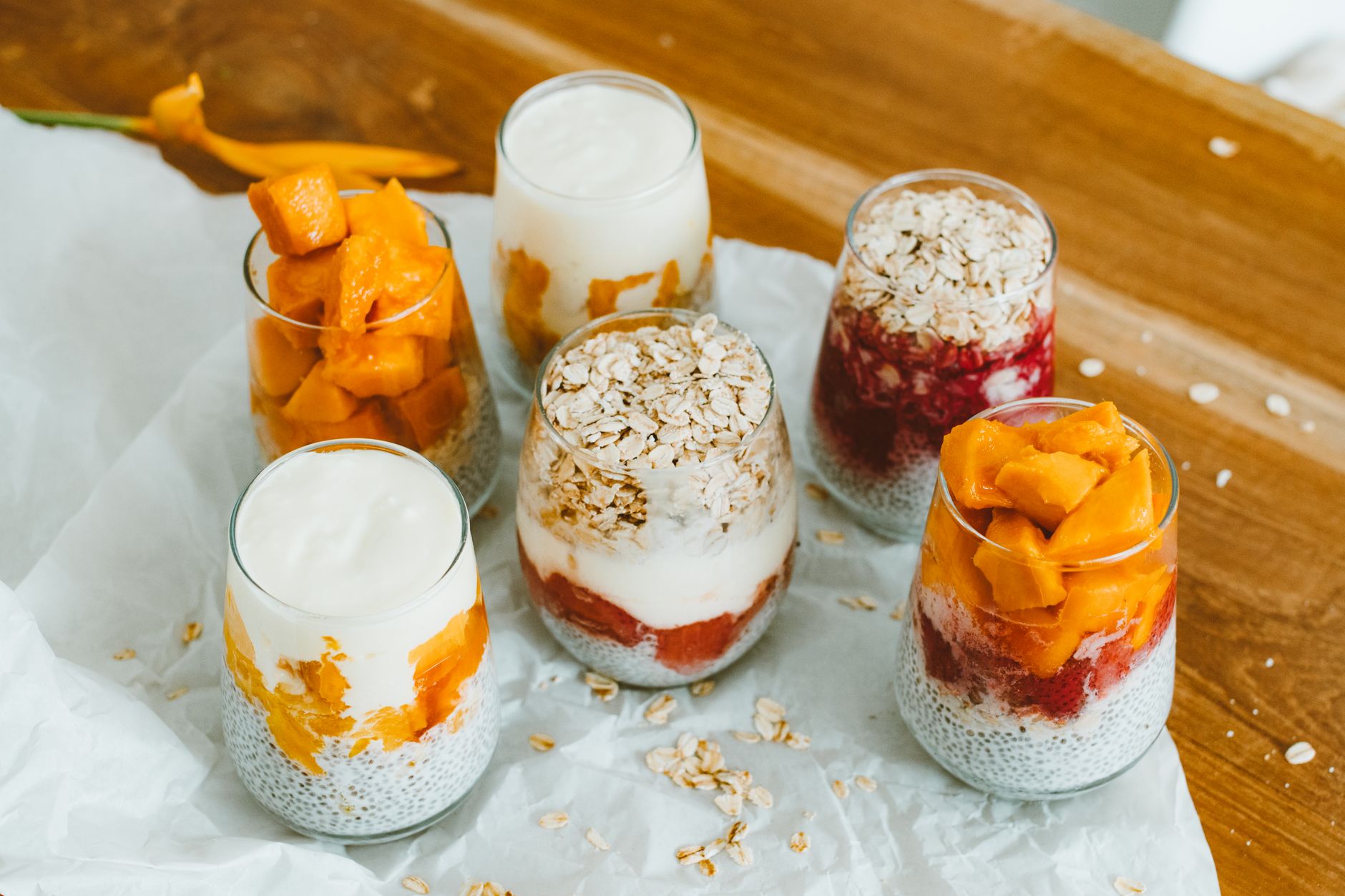 Fancy Yet Easy Mother's Day Desserts to Impress Colorful fruit and yogurt parfaits in glasses with oats, perfect for a healthy breakfast.