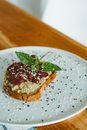 Brown Bread With Red and Green Leaf on White Ceramic Plate