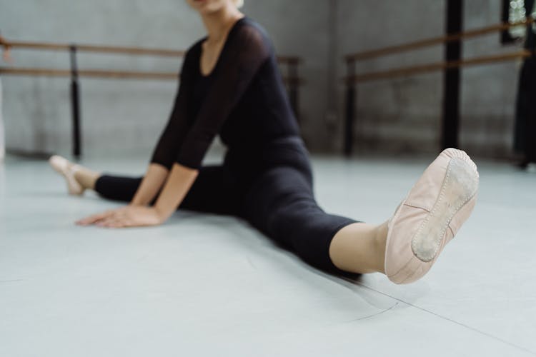 Ballet Dancer Practicing Split In Spacious Studio