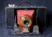 Black and Red Camera on Blue Textile