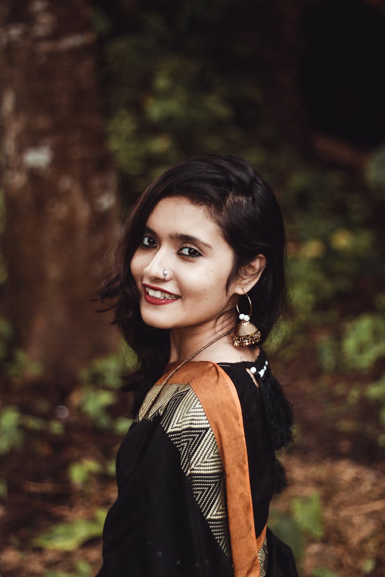 Happy Indian Woman In Traditional Garment In Forest