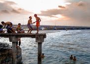 Boys Playing on Jetty by Sea