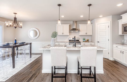 A modern kitchen with an elegant dining area featuring sleek furniture and contemporary design.
