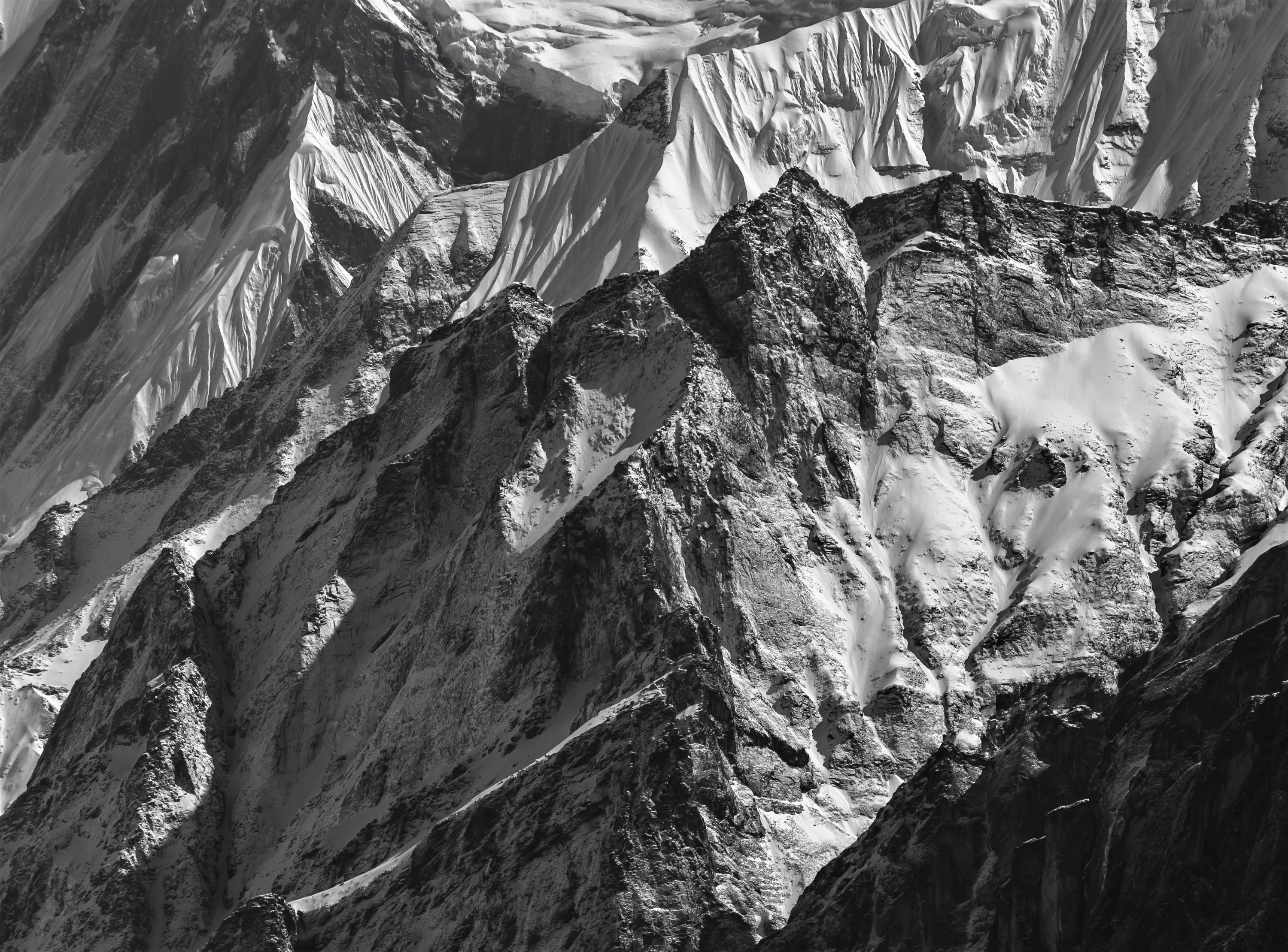 Stunning black and white image of the snow-capped Himalayan mountains in Nepal, capturing their dramatic texture.