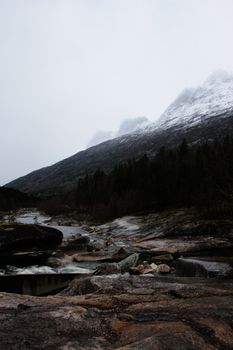Explore the rugged beauty of a Norwegian mountain landscape with a flowing river.