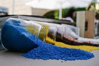 Blue Textile Beside Clear Glass Bottle