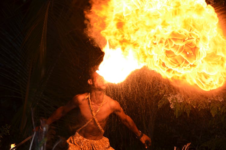 Shirtless Man Blowing Fire