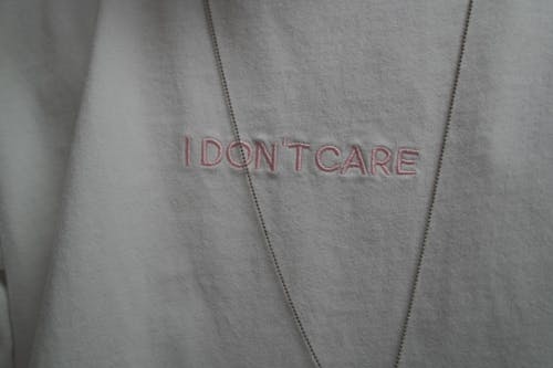 I Don't Care Text Embroidered on White Cloth