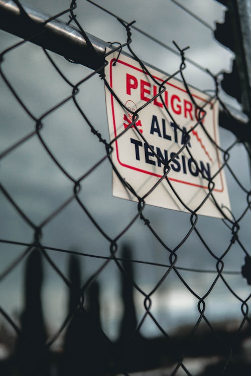 Free Warning Sign on Chain Link Fence Stock Photo