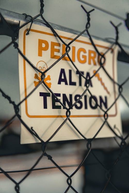 Warning Sign on Chain Link Fence