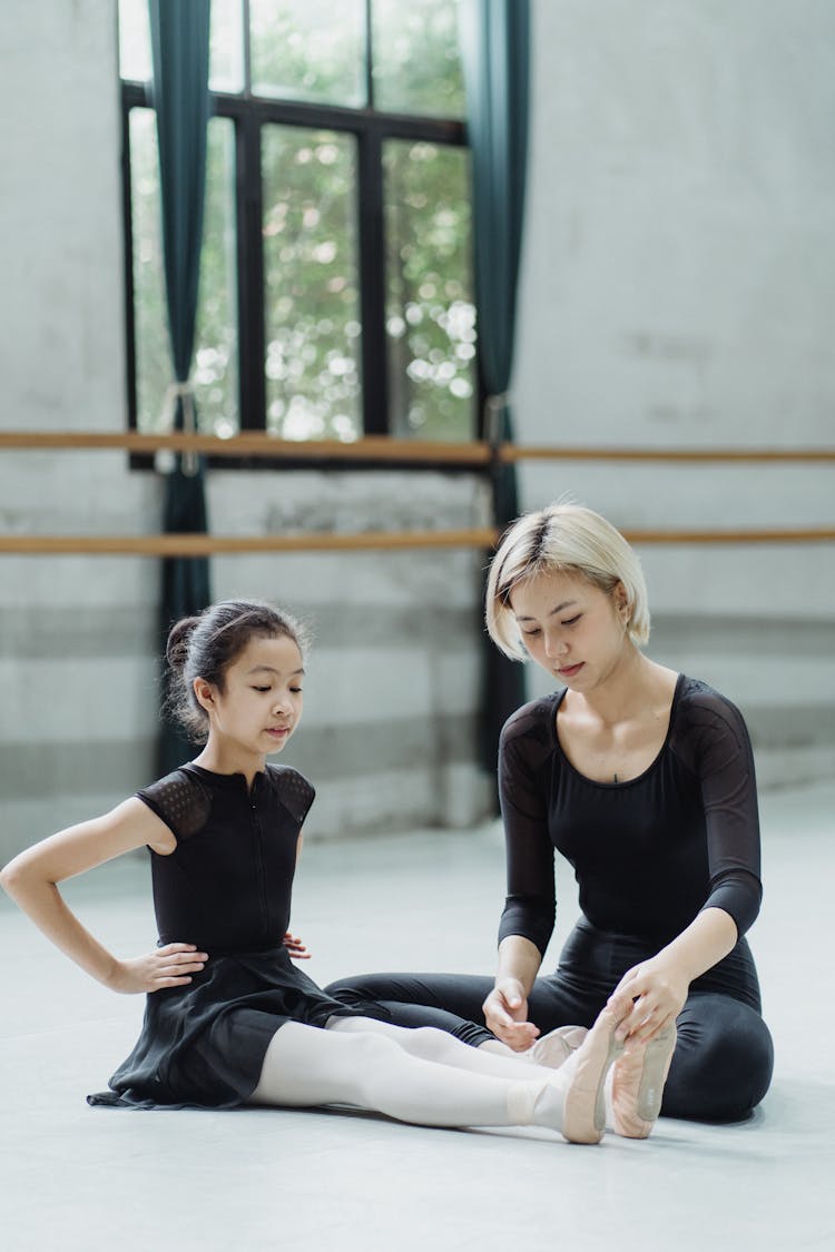 Asian Ballet Teacher With Pupil During Workout In Hall