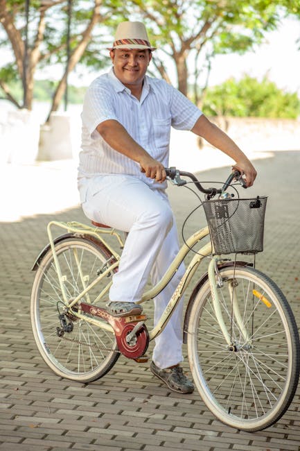A person falling while riding a bicycle, but smiling and getting back up with determination