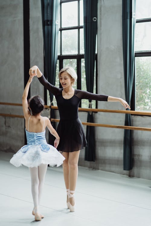 Free Slender Asian ballerinas performing dance in studio Stock Photo