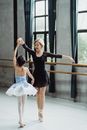 Slender Asian ballerinas performing dance in studio