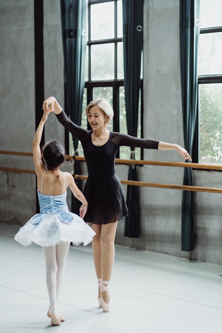 Slender Asian Ballerinas Performing Dance In Studio